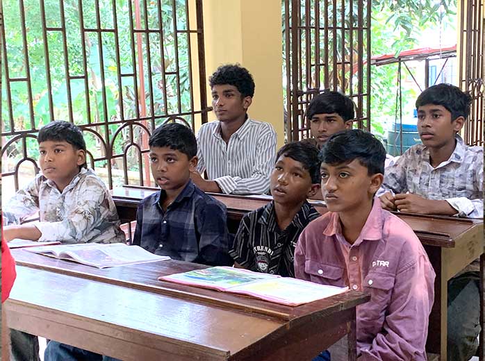 Children learning with a teacher at the Gurukulam